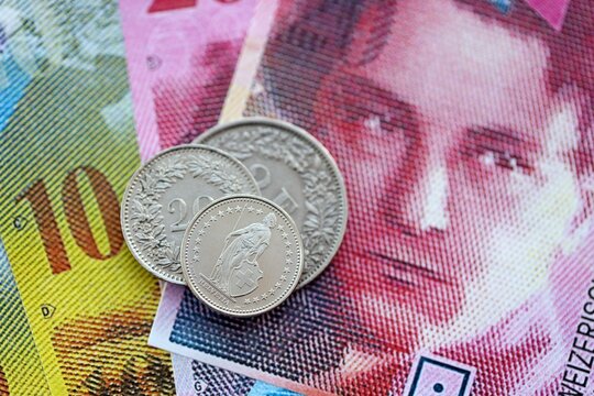 Currency of Switzerland. Banknotes and Swiss franc coins on them. Financial topics in Swiss banking concept.