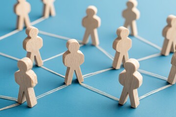 Obraz premium Networked: A conceptual image of interconnectedness, depicting wooden figures linked together by lines, suggesting a network or system.