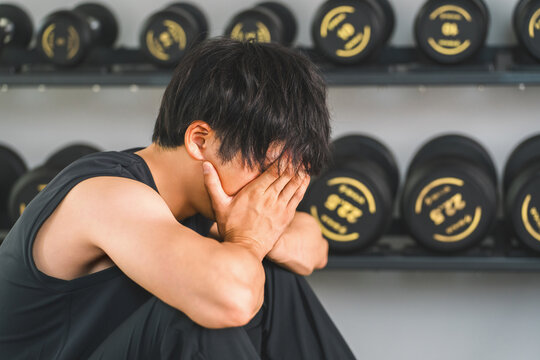 Asian men who lack motivation at the gym/sports gym (overwork, fatigue, exhaustion, depression)