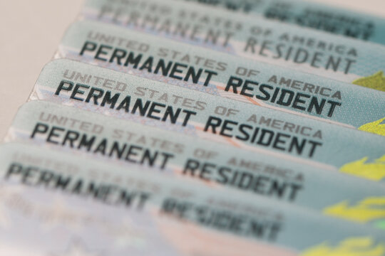 United States Permanent Resident cards stacked together. Concept of immigration, residency status, identity documentation, and legal authorization to live and work in the USA.