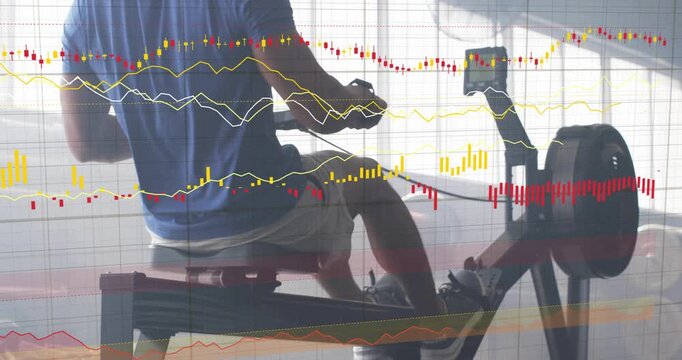 Adult male rower initiating drive from catch, pulling handle and checking console for performance