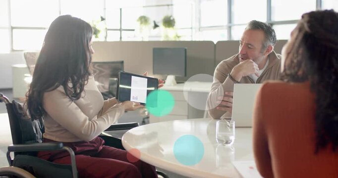 Tapping tablet, woman in wheelchair presenting chart, rotating, guiding team while bubbles drifting