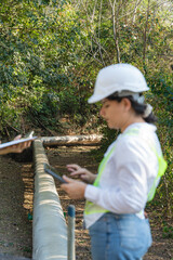 Engineer inspecting geothermal energy pipeline at miravalles volcano, costa rica