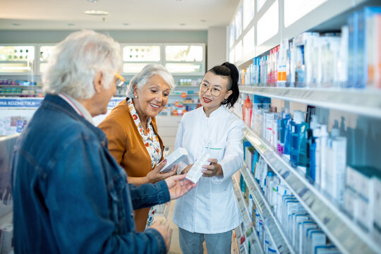 Senior couple consulting pharmacist in a modern pharmacy