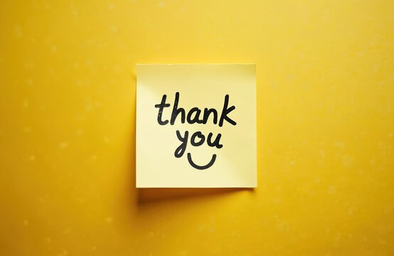 Yellow sticky note with handwritten thank you message and face. Simple graphic for expressing gratitude or appreciation in business or personal life.
