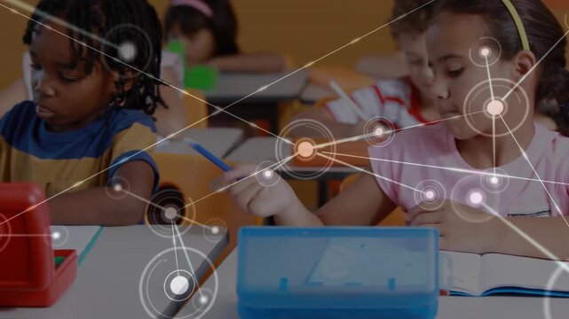 Camera panning, front-row kids using pencils for classwork while overlay aligning nodes over desks