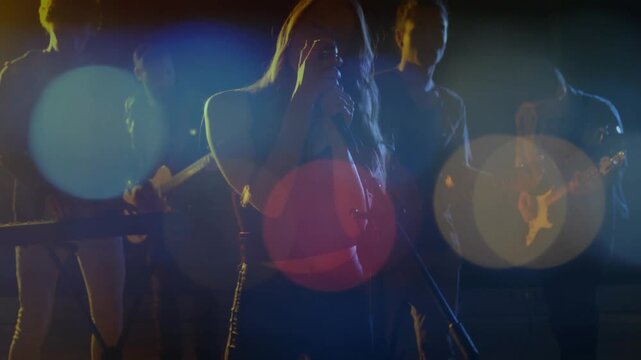 Camera rising revealing singer moving center singing for music show lens flares overlaying