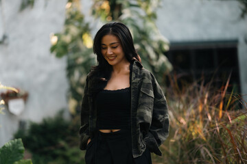 Fototapeta premium Asian woman relaxing in forest nature wellness mindfulness peaceful outdoor lifestyle mental health wellbeing natural therapy environment calm happiness sitting among trees