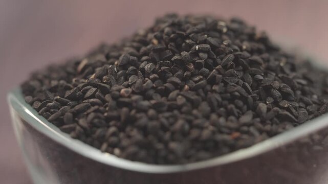 Black cumin seeds in a glass dish on a table