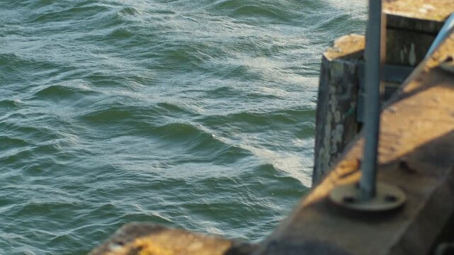 Static shot of waves lapping alongside Bernera pier on the Outer Hebrides.