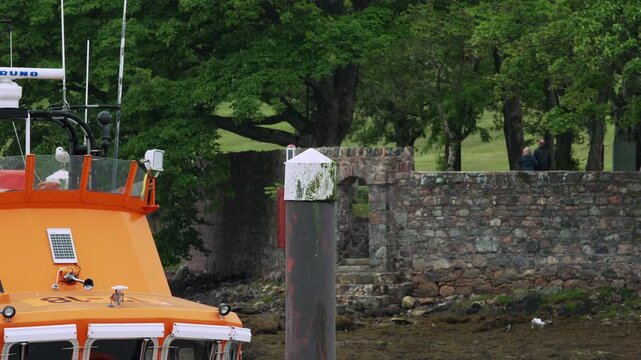 Slow motion shot of a seagull taking off from a pontoon at Stornoway harbour.