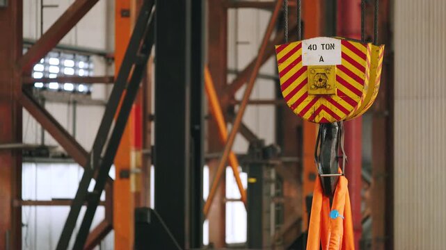 Static shot of an industrial crane inside a metal fabrication plant on Lewis.