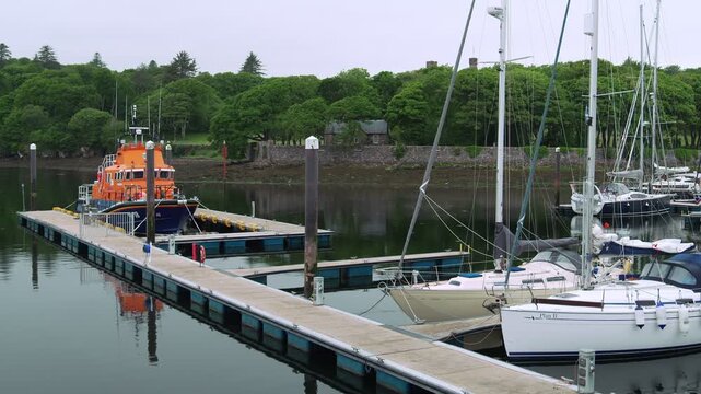 Static shot of a coastguard rescue vessel moored at the Stornoway pontoon dock.