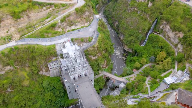 The stunning Las Lajas Sanctuary in a scenic landscape, surrounded by green hills and a rushing river below.
