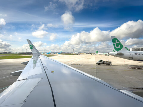 PARIS, FRANCE - MARCH 1, 2026: Transavia aircraft stand ready on the apron at Paris Orly Airport, France, seen from a passenger window. Transavia is a dutch low cost carrier part of Air France KLM.