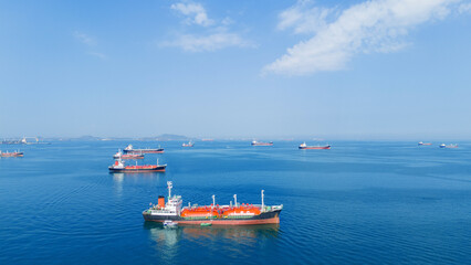 LPG gas and oil tanker ships anchored in the blue ocean. Industrial maritime transport, global energy logistics, and fossil fuel import export trade concept. © Yellow Boat