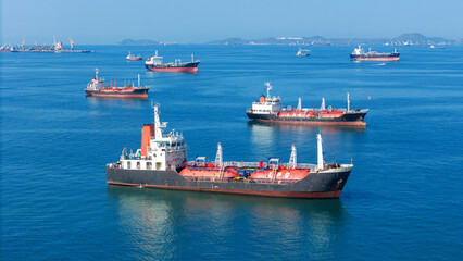 LPG gas and oil tanker ships anchored in the blue ocean. Industrial maritime transport, global energy logistics, and fossil fuel import export trade concept. © Yellow Boat