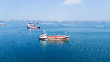 LPG gas and oil tanker ships anchored in the blue ocean. Industrial maritime transport, global...