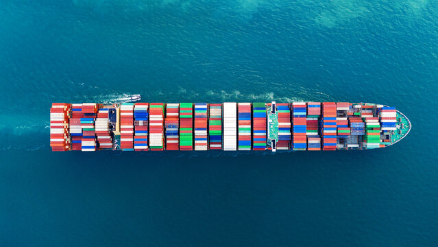 container ship cargo. Global trade logistics, supply chain disruption, energy crisis, war tension, Strait of Hormuz blockade, and palm oil commodity export concept.