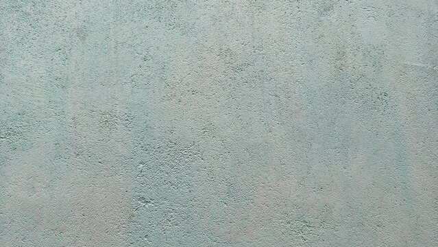 Aged green concrete wall texture, rough grunge cement background with worn surface.