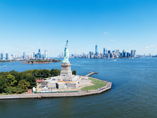 Aerial drone view of Statue of Liberty on Liberty Island with Manhattan skyline and New York Harbor, NYC USA. g. © Artem Onoprienko