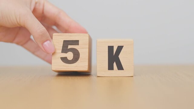 hand change wooden block from 4K to 5K, display resolution, Ultra High Definition, UHD, pixels, Technology, network, TV streaming, Social media and digital concepts