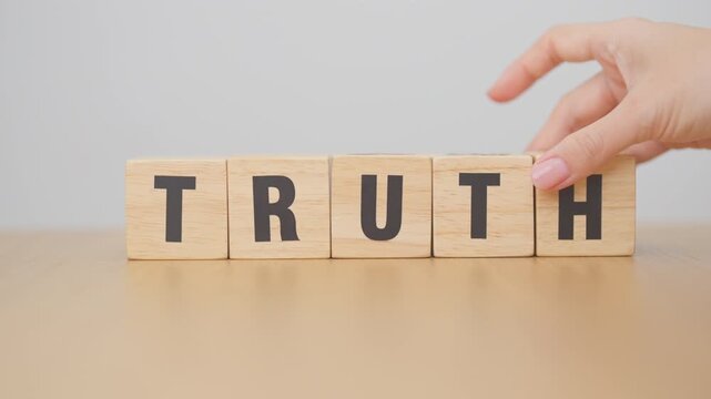 hand change wooden block TRUST to TRUTH. Trustworthy, Truth, beliefs business and agreement concept