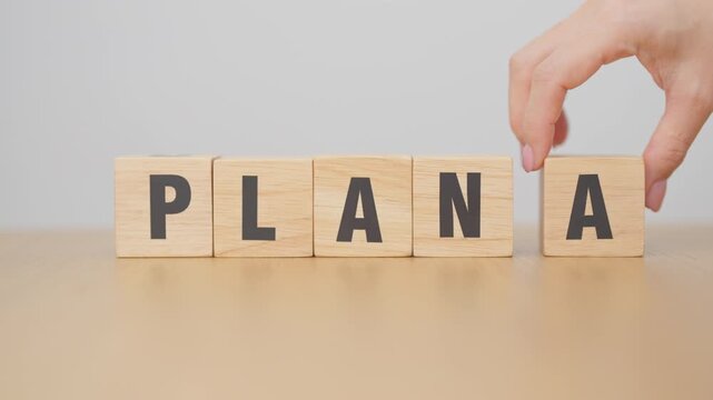hand change wooden block PLAN A to PLAN B. strategy, leadership, management, marketing, project and finance concepts