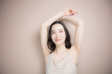 Fototapeta premium Image of beauty and spa treatments for young women, such as underarm hair removal, on a pink-beige background