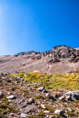 Fototapeta premium Rugged mountains rise beneath a clear, vivid blue sky