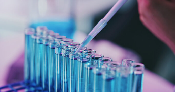 Hand, test tube and scientist with dropper for medical experiment, drug development or chemistry. Chemical, pipette or person in lab for science innovation, cure or investigation for research closeup