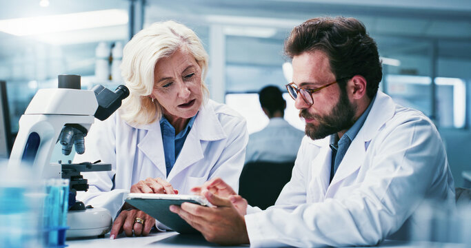 Tablet, research and people in meeting, science and discussion for experiment results. Scientist, man and woman in forensics lab, teamwork and biotech for pharmaceutical drug proposal or medical test