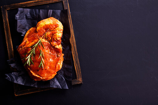 Raw meat. Raw pork ribs in marinade with spices, rosemary, tomato sauce and garlic