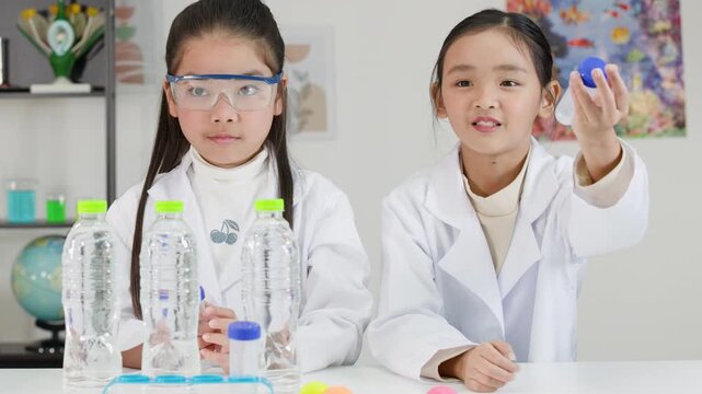 Asian Students Conduct Bernoulli's Principle Science Experiment with Ping Pong Balls