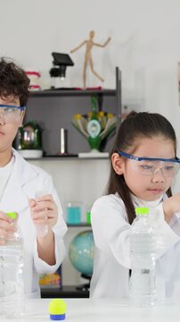 Asian Students Conduct Bernoulli's Principle Science Experiment with Ping Pong Balls