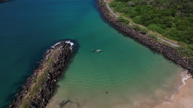 People Swimming At The Secluded Marlo Beach By The Tweed River At Fingal Head In New South Wales, Australia. Aerial Shot