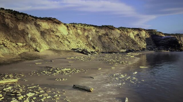 Seaside cliff aerials. Expansive aerial view of shoreline terrain. Highaltitude image capturing vastness of coastal cliffs and intricate shoreline features
