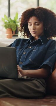 Business, woman and typing on laptop in home for news article, editing submission and remote work. Freelance journalist, african person and tech on sofa for blog post, online research and publication