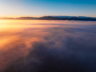 Fototapeta premium Aerial view of Liptov region at sunrise with High Tatras mountains in the background, Slovakia