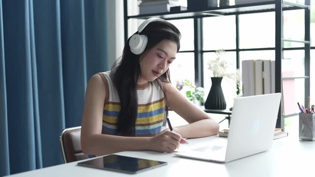 Asian Female University Student Studying Online on Laptop