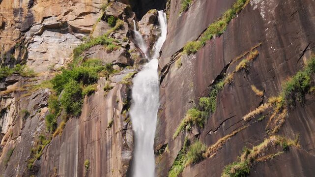 4K Slow motion shot of Jogini waterfall falling from the cliff during the winter season near Manali in Himachal Pradesh, India. Scenic view of waterfall during the winter season background.