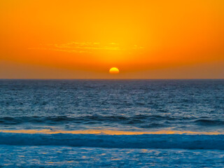 Fototapeta premium Sunrise at the Seaside with a hazy cloudless sky