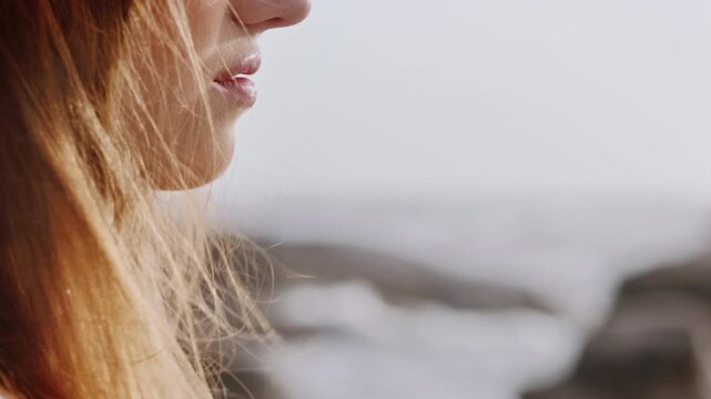 Calm, wind and woman by beach on holiday, getaway or weekend trip with space for relax. Travel, breeze and female person by ocean or sea in summer vacation for self reflection, nostalgia or memory.