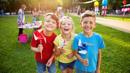 Children celebrating International Childrens Day at an outdoor fair with pinwheels