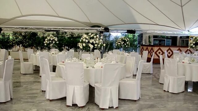 Elegant Wedding Reception Hall with White Floral Centerpieces. 