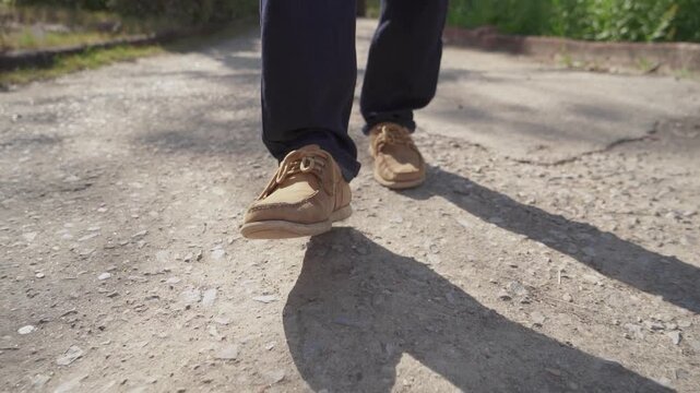Low Angle View of a Man's shoes, walking on a road in Slow Motion - Men Shoe Walking in Casual Outfit