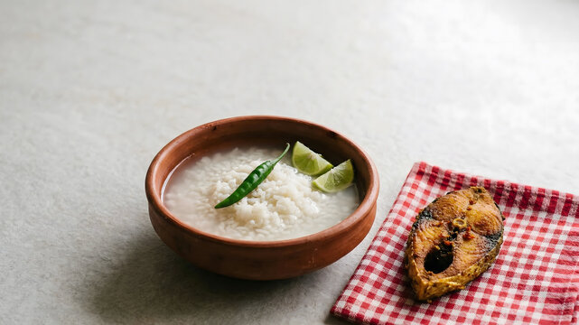 Traditional Bangladeshi Panta Bhat with Fried Hilsa Fish on Gamcha Cloth, Clay Bowl, Soft Natural Light, Minimalist Composition, Top View