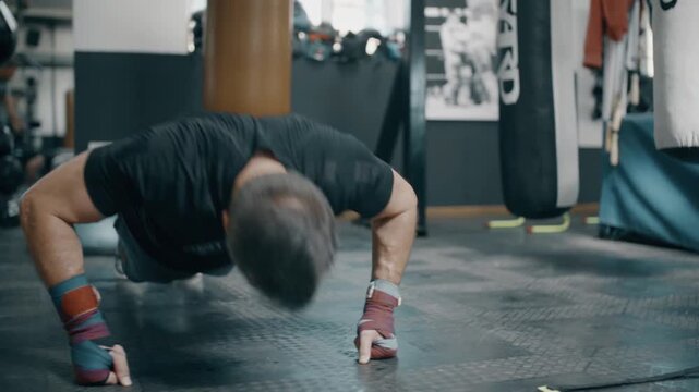 young man doing push ups in gym