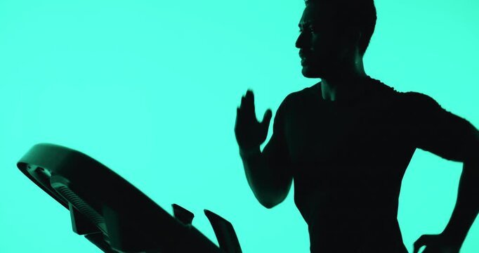 Running, treadmill and man with training, green screen and cardio workout on studio background. Balance, fitness and healthy person with machine, equipment for exercise and challenge for wellness