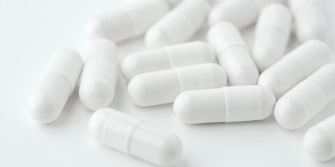 White pills on a white background. Close up